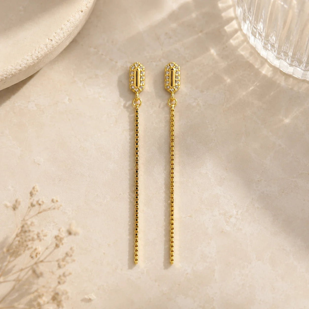 18K gold-filled chain drop earrings with pavé CZ studs on ivory fabric