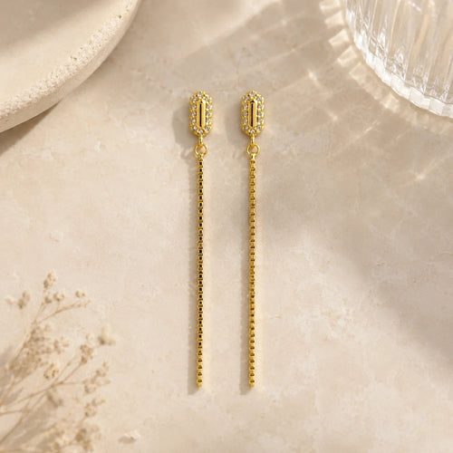 18K gold-filled chain drop earrings with pavé CZ studs on ivory fabric