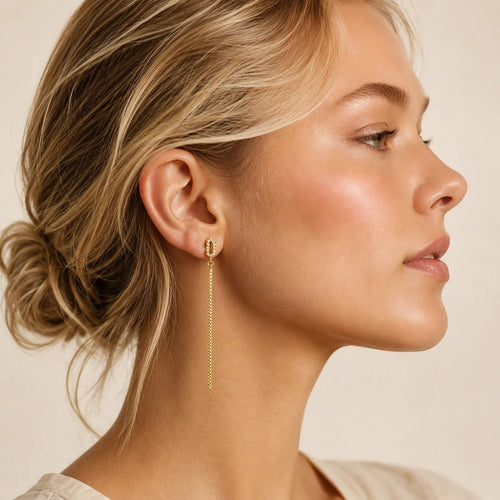 Model wearing long gold-filled chain drop earring with pavé CZ stud