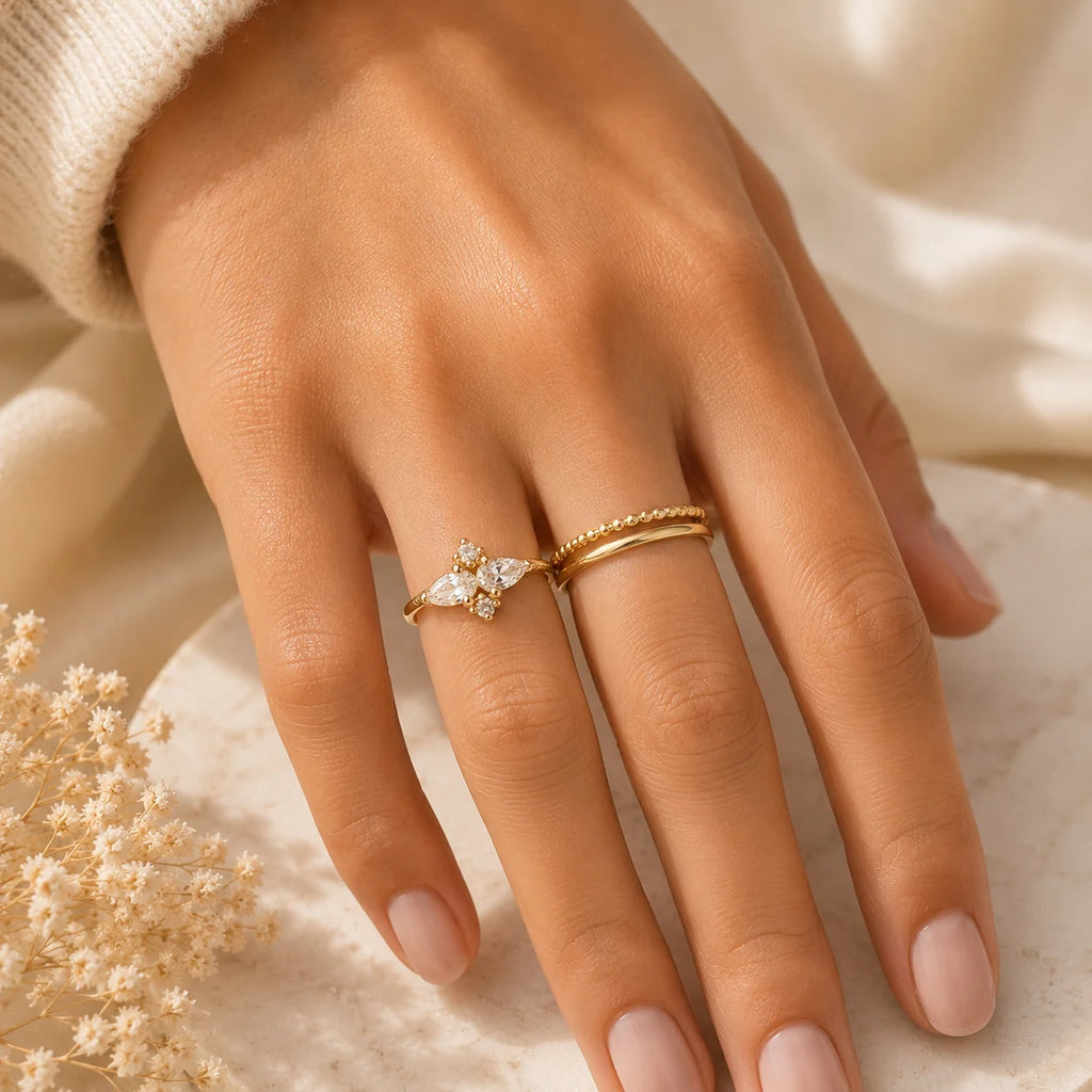 Woman wearing Ma Vie dainty flower ring 18k gold filled with pavé CZ at sunlit café