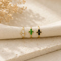 Flat lay of Ma Vie dainty flower ring on cream silk with baby's breath, 18k gold filled vintage CZ