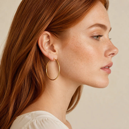Model wearing lightweight gold-filled endless hoop earrings in profile