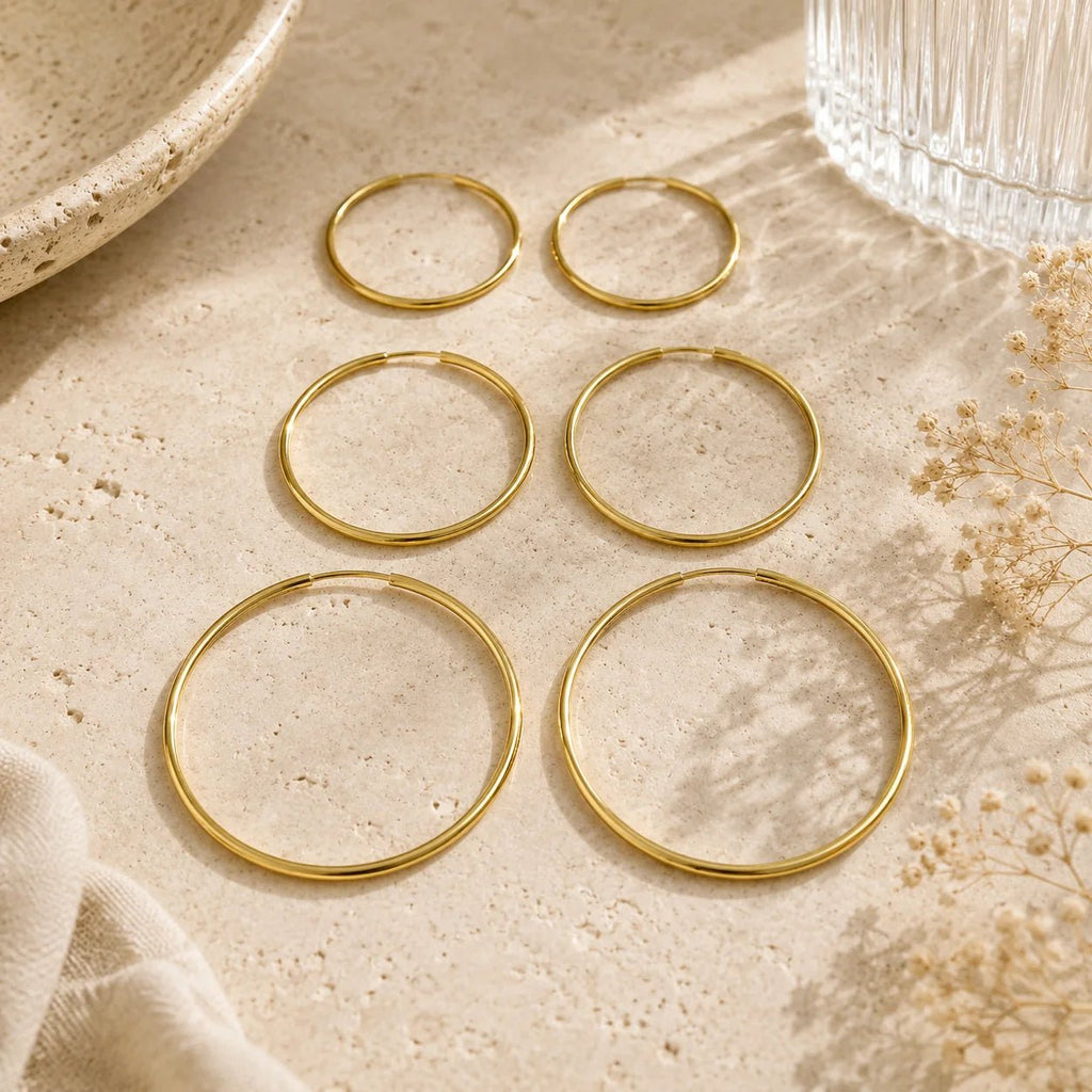 Gold-filled endless hoop earrings displayed in three available sizes