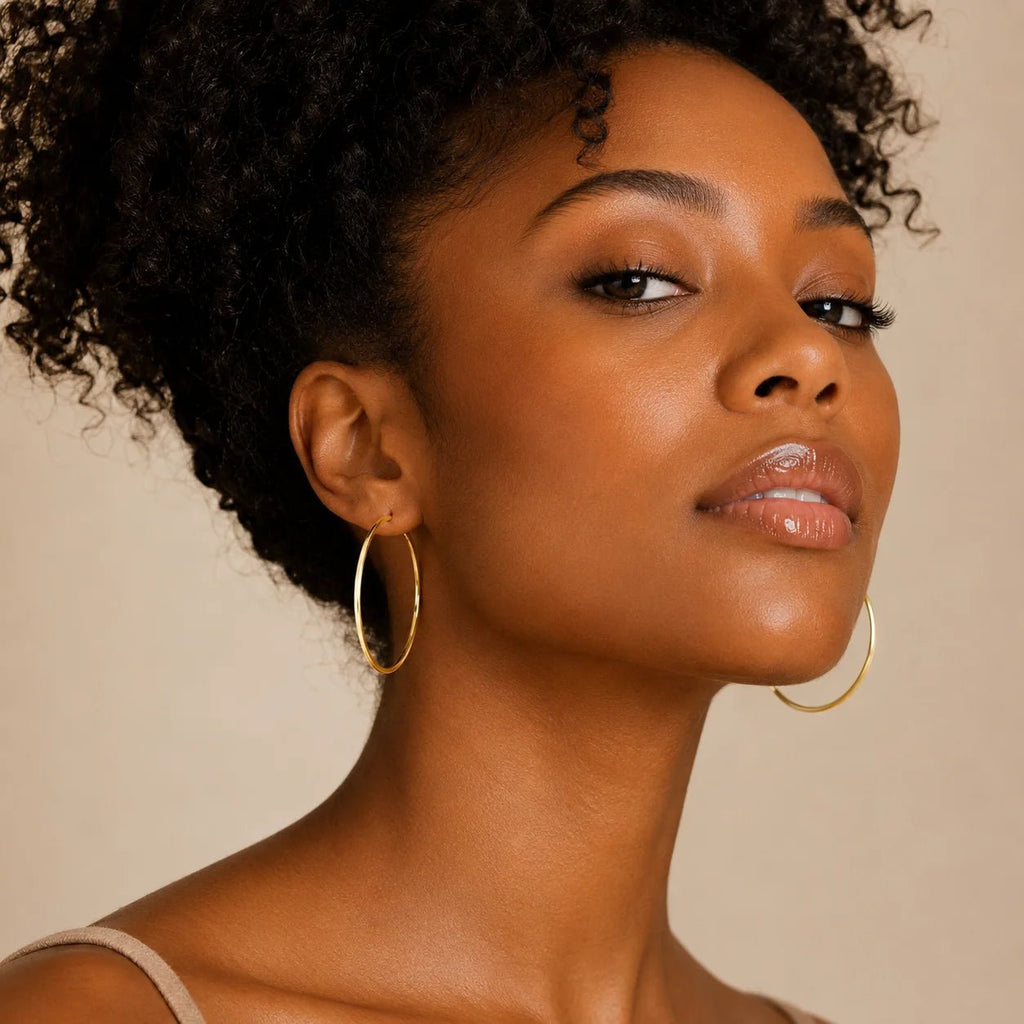 Model wearing large lightweight gold-filled hoop earrings