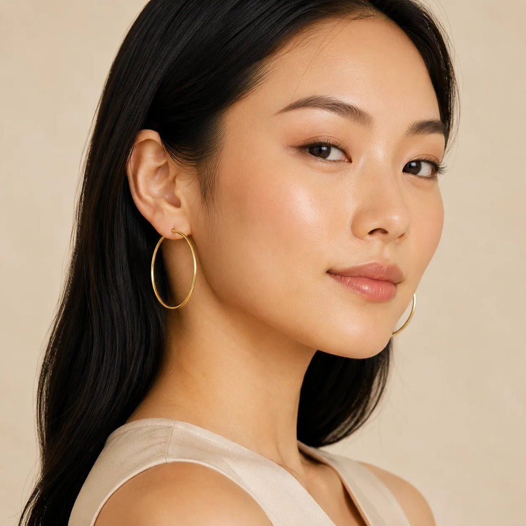 Model wearing minimalist gold-filled hoop earrings in profile