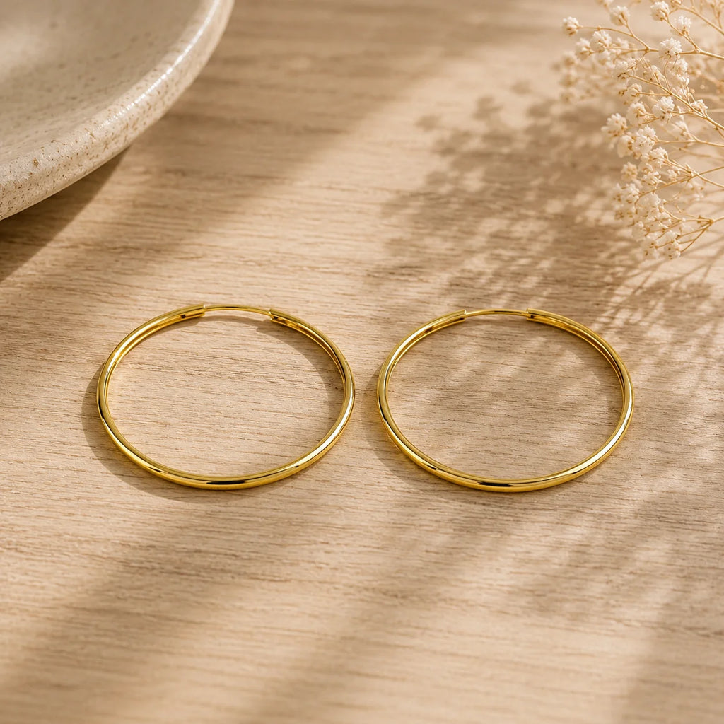 Close up of Ma Vie everyday hoop earrings 18k gold filled hollowed endless design