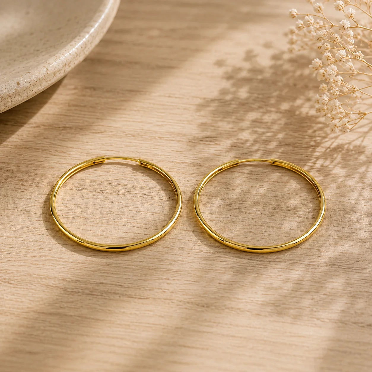 Close up of Ma Vie everyday hoop earrings 18k gold filled hollowed endless design