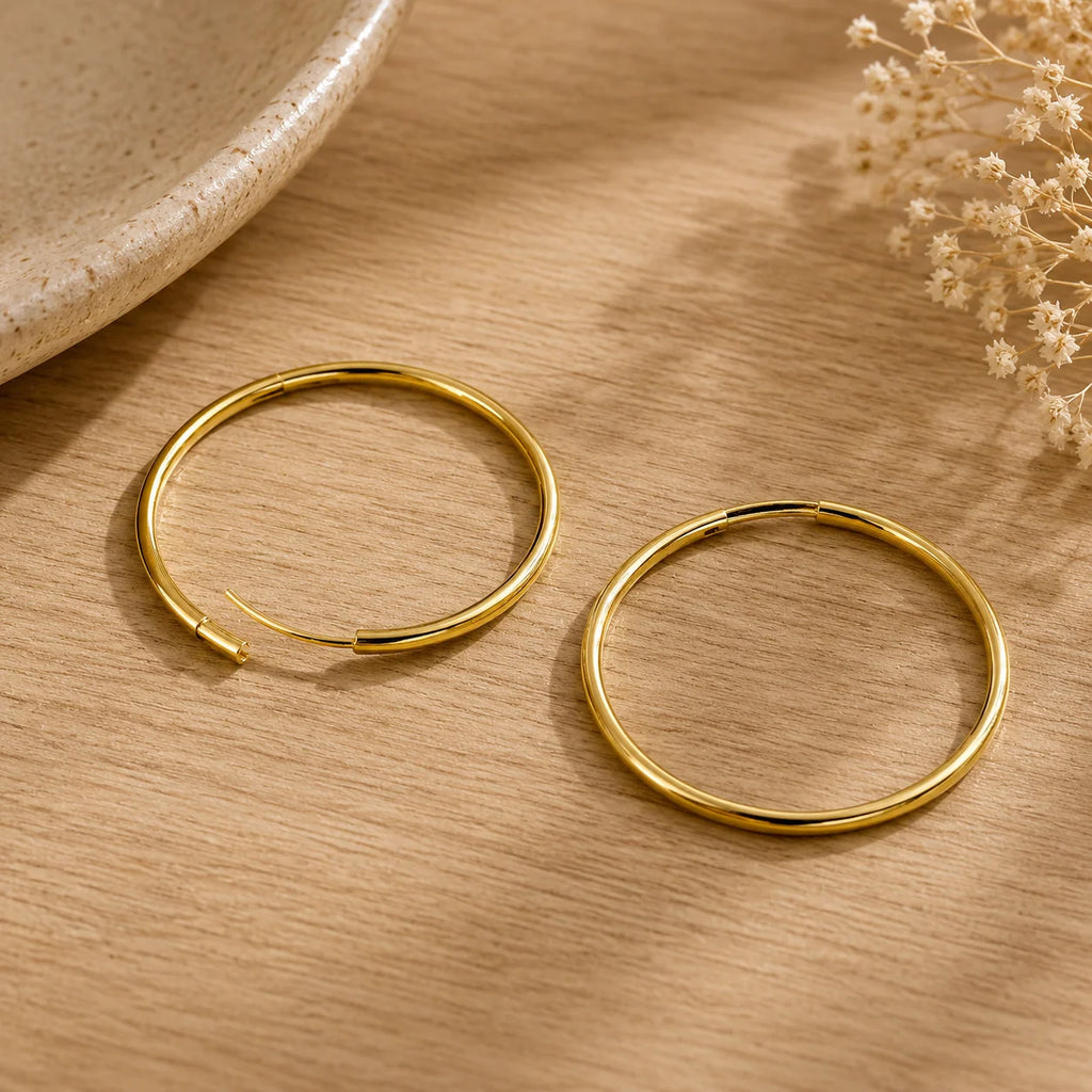 Flat lay of Ma Vie everyday hoop earrings 18k gold filled endless lightweight design