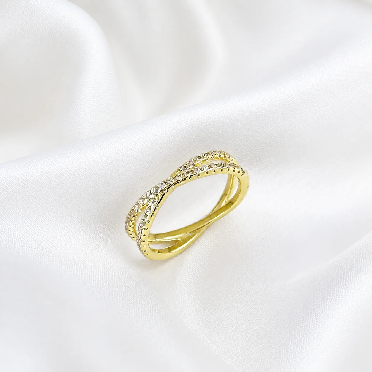 Gold filled CZ X ring standing on silk, crossover design with cubic zirconia