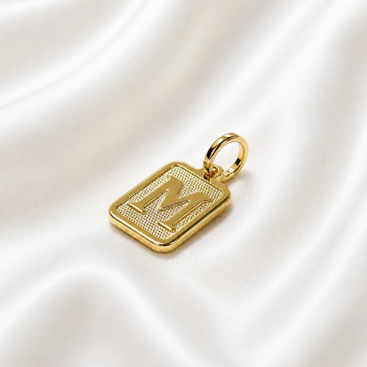 Letter M textured 18K gold-filled initial pendant on ivory silk