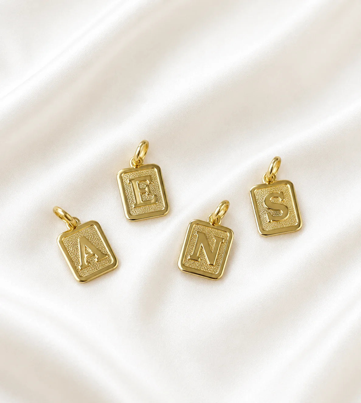 Group of Ma Vie initial pendants 18k gold filled with textured letters A E N S, personalized necklace