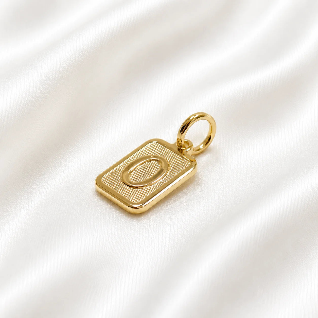 Initial pendant letter O in 18k gold filled, textured square charm on cream silk