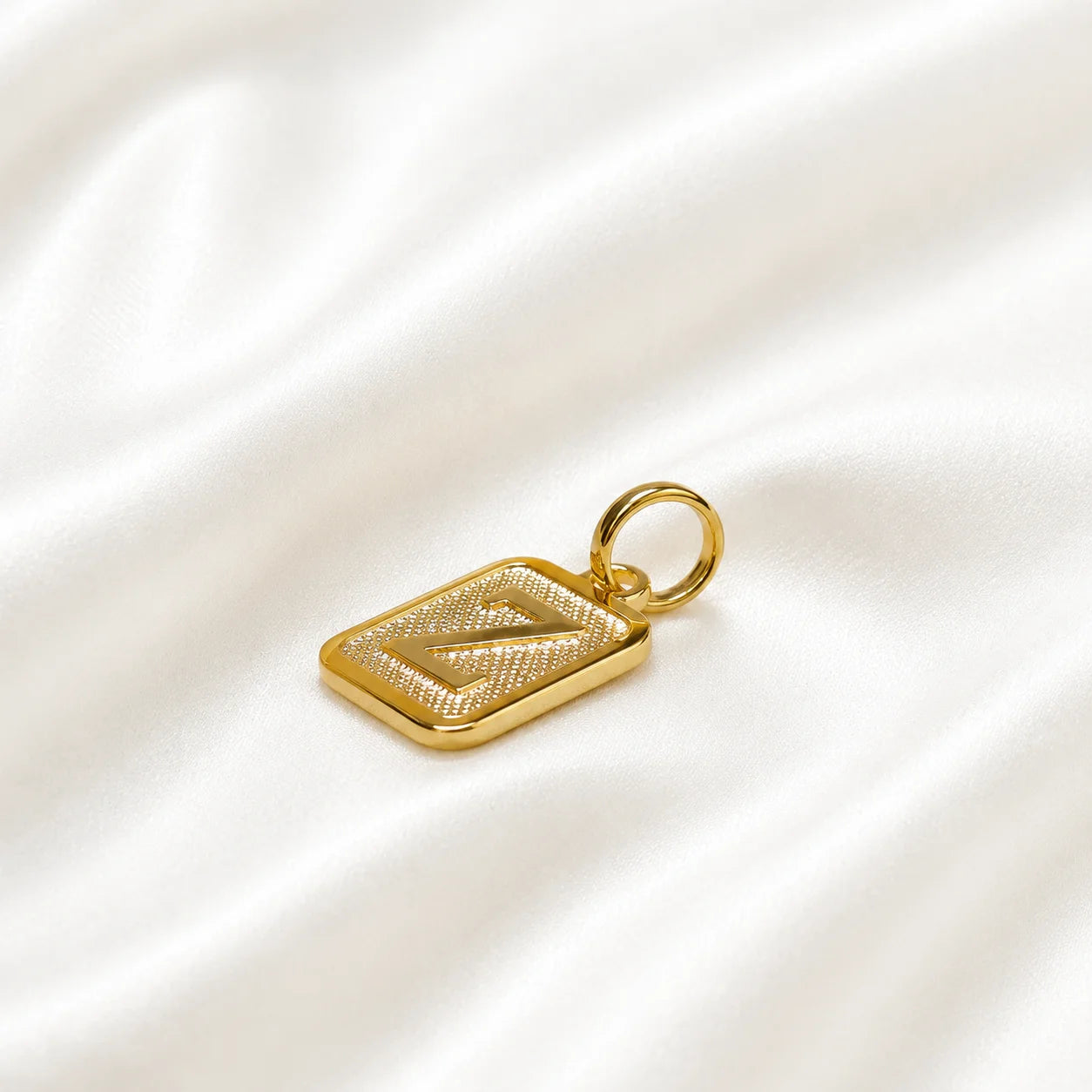 Initial pendant letter z in 18k gold filled, textured square charm on cream silk