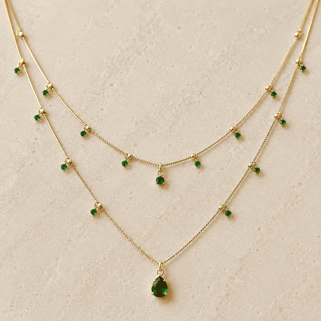 Green cubic zirconia layered teardrop necklace on ivory stone