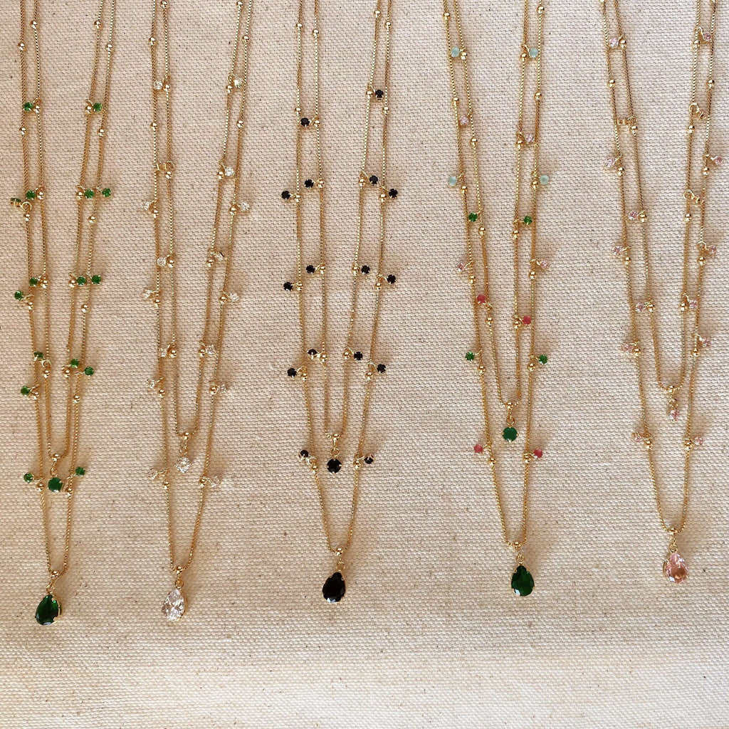 Layered teardrop necklaces displayed in five cubic zirconia color options