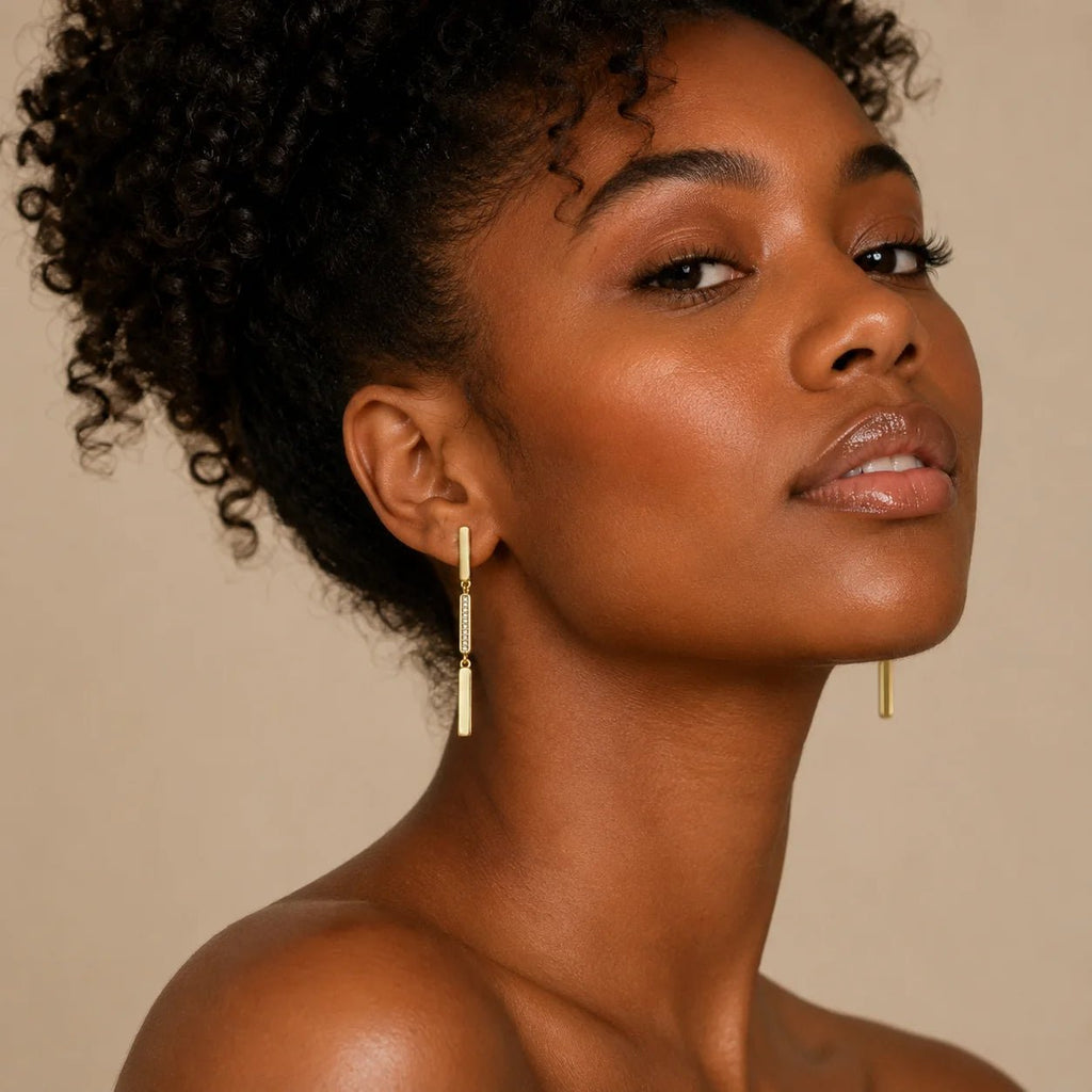 Model wearing lightweight linear drop earrings with pavé CZ center detail