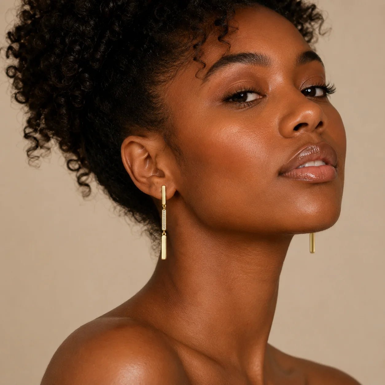 Model wearing lightweight linear drop earrings with pavé CZ center detail