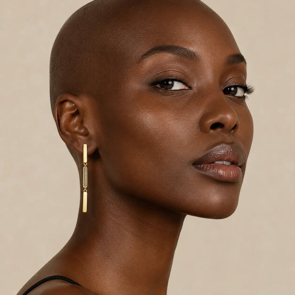 Model wearing 18K gold-filled linear drop earrings with pavé CZ detail