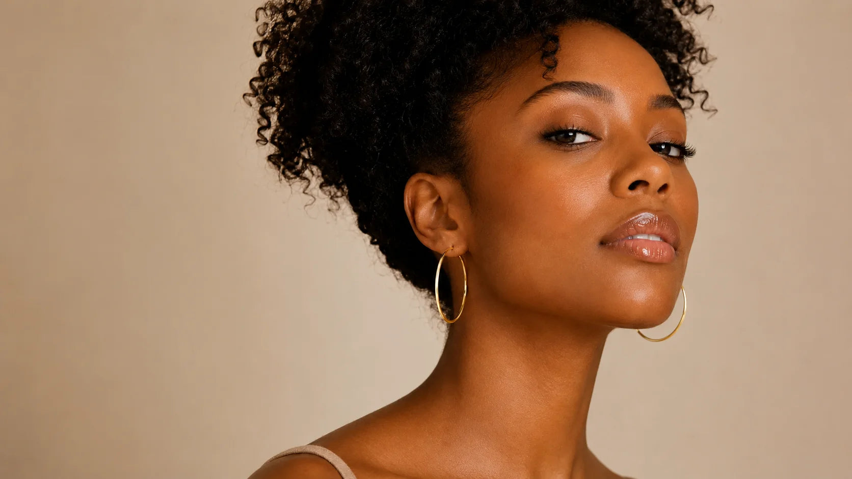 Woman with natural hair wearing Ma Vie 18k gold filled jewelry, hypoallergenic daily wear